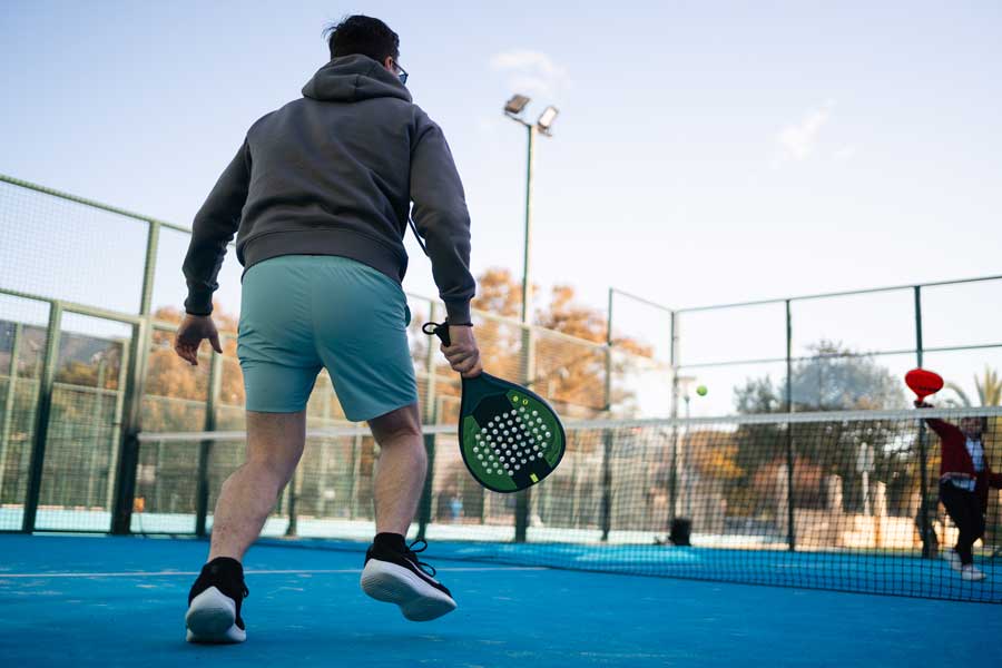A man prepares for a backhand shot in padel tennis at Tucson Racquet & Fitness Club in Tucson A man prepares for a backhand shot in padel tennis at Tucson Racquet & Fitness Club in Tucson