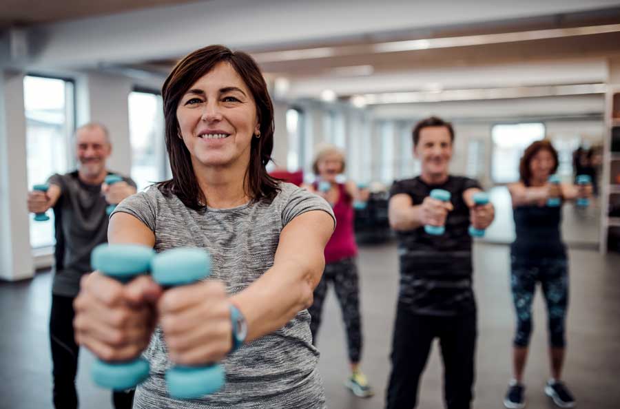 group-of-cheerful-seniors-in-fitness-center-in-Tucson Group of seniors attending a fitness class in a fitness center in Tucson